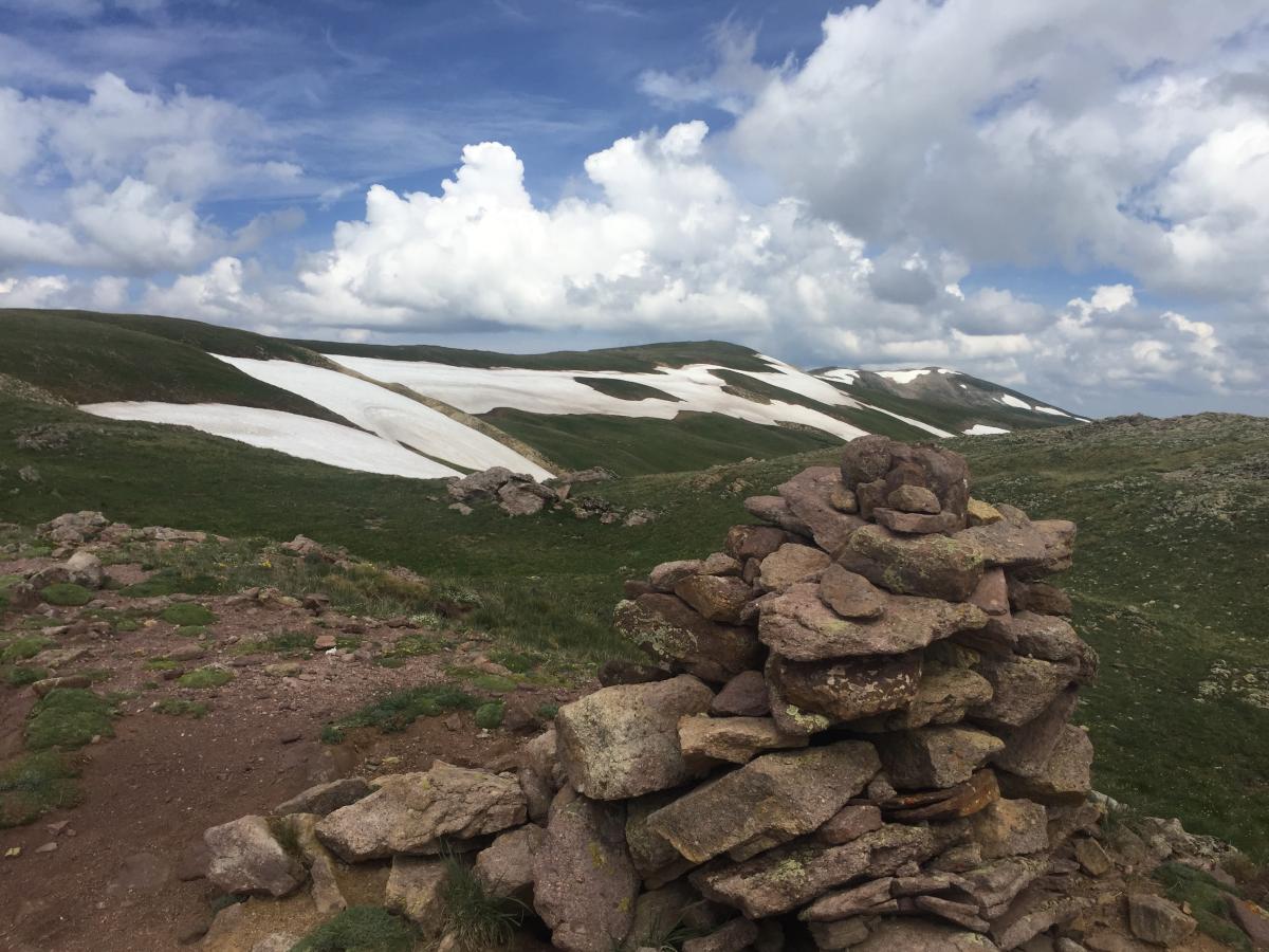 Another shot of the high country above the tree line. Still snow up there even in late July. The stack of rocks is called a cairn and is a universal trail marker. I did not have any trouble staying on the trail, but the cairns would be helpful in snowier conditions. 